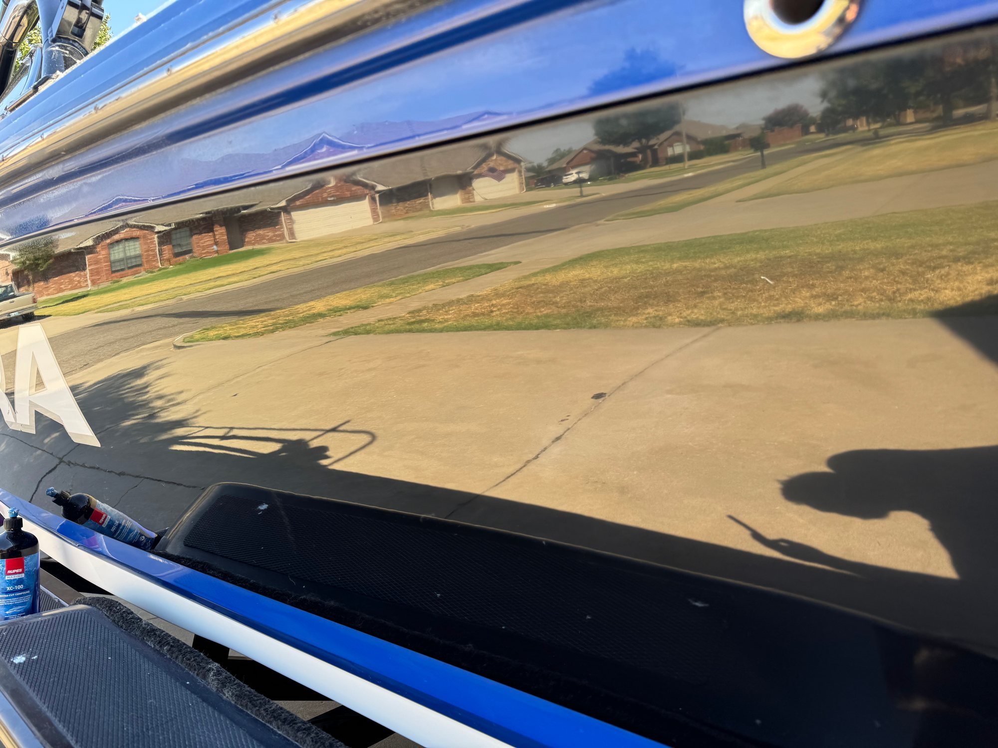 After: the neighborhood reflected sharply in the corrected black gelcoat
