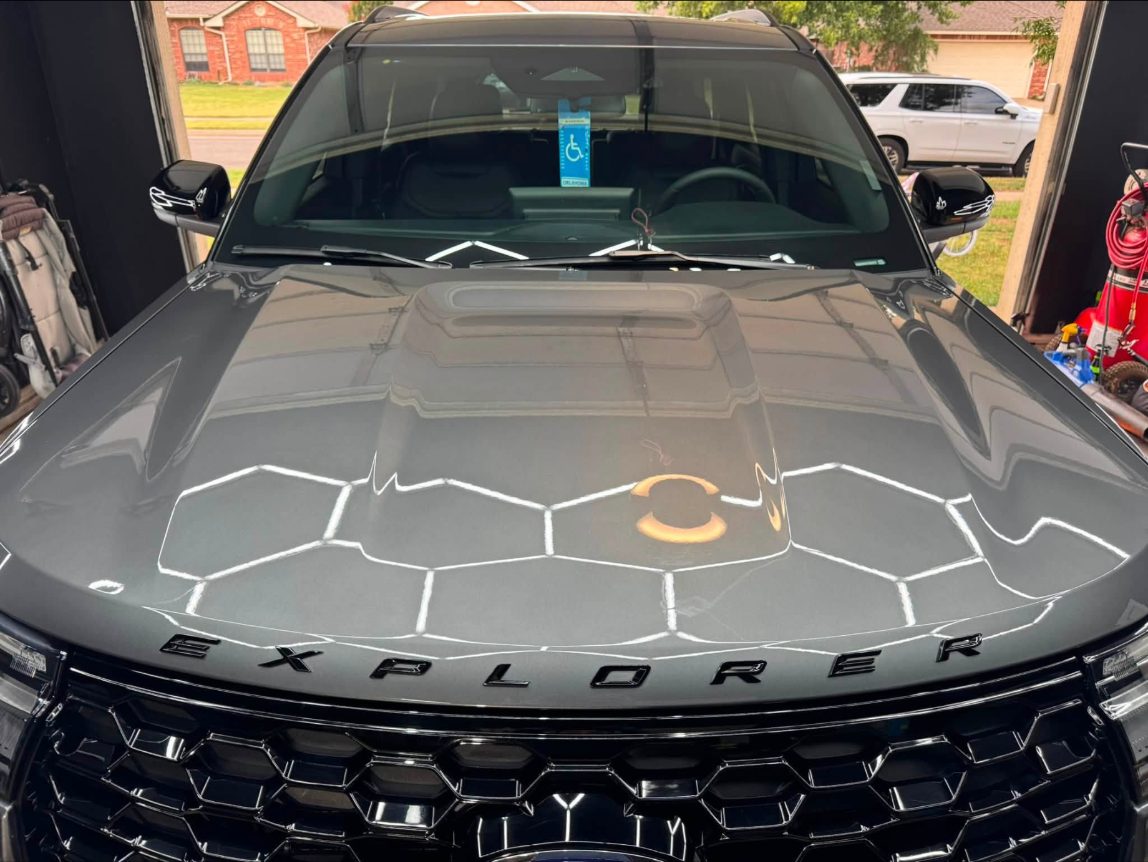Ford Explorer hood after machine polishing, hex lights reflected cleanly