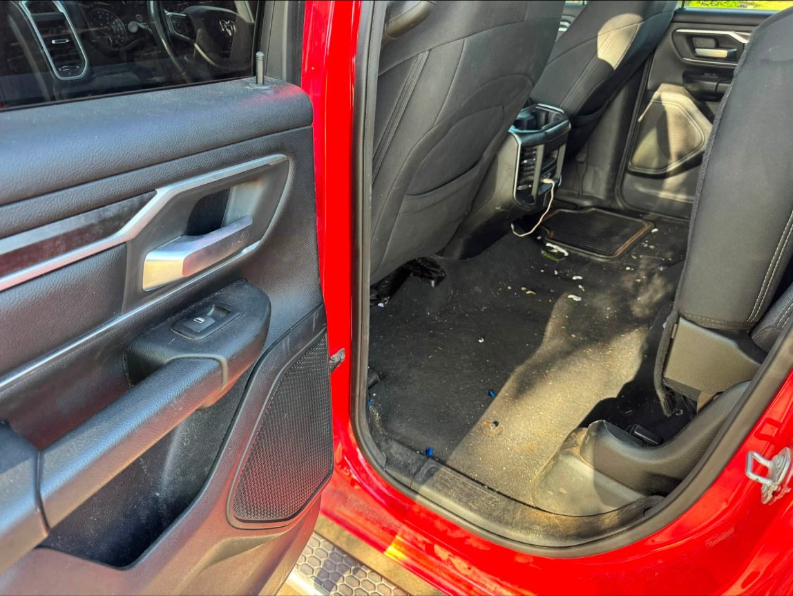 Rear seat floor before cleaning, debris and stains